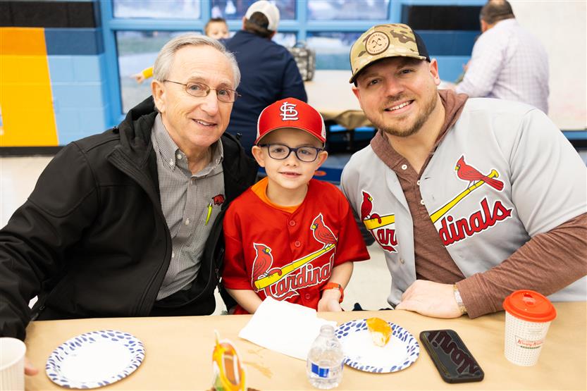 Trinity Elementary students eat donuts with dudes